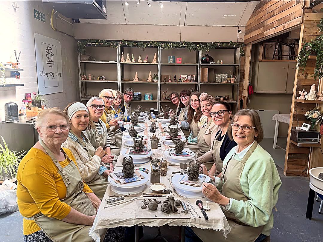 A guest hand building at the studio