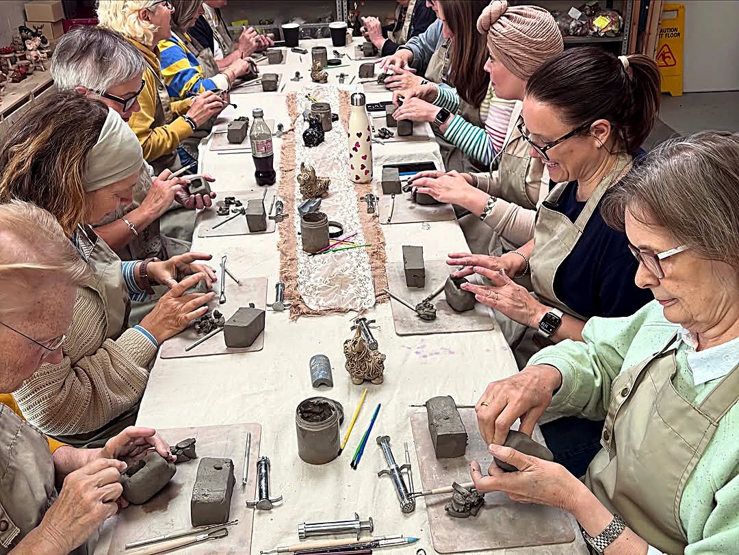 A large group pottery event around the table